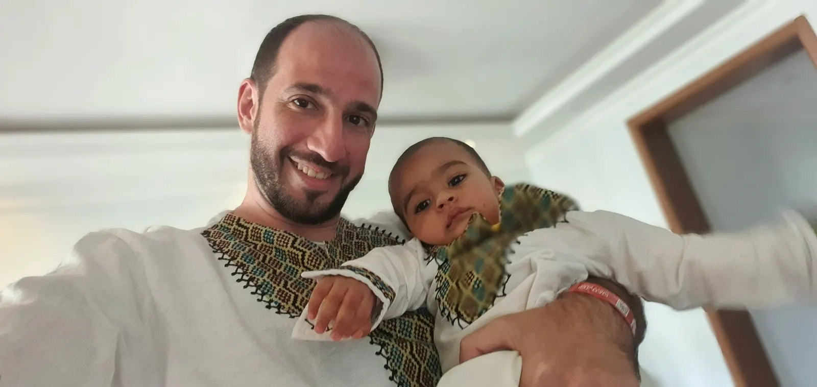 Smiling father holding his baby